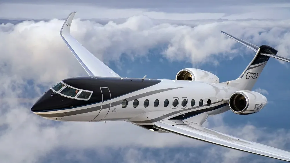 Gulfstream jet in flight above clouds